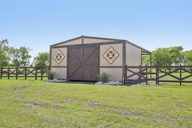view of outdoor structure featuring fence and an outbuilding
