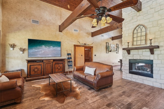living room with wood finished floors, high vaulted ceiling, beamed ceiling, and visible vents
