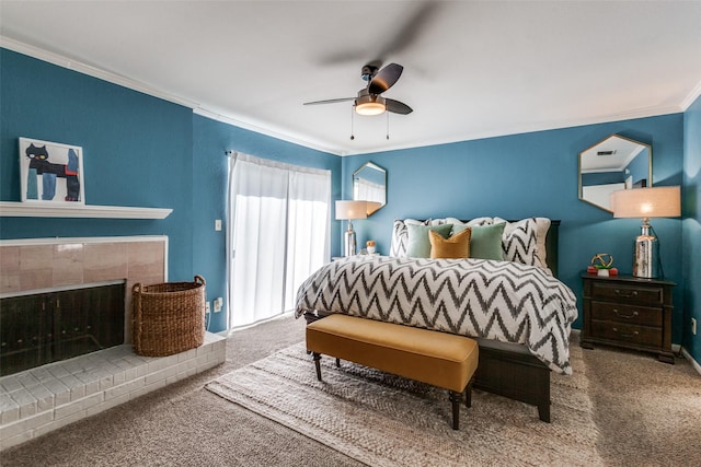 carpeted bedroom with crown molding, baseboards, a ceiling fan, and a tiled fireplace