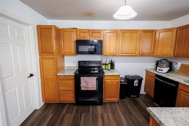 8820 Guadalupe Rd, Fort Worth, TX 76116 - kitchen with dark wood-style flooring, brown cabinetry, black appliances, and light stone countertops