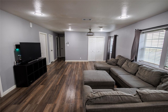 8820 Guadalupe Rd, Fort Worth, TX 76116 - living area featuring dark wood-type flooring, visible vents, and baseboards