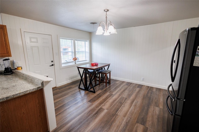 8820 Guadalupe Rd, Fort Worth, TX 76116 - dining space featuring visible vents, baseboards, a notable chandelier, dark wood-style flooring, and wooden walls
