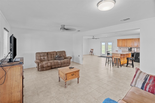 9518 County Road 913, Godley, TX 76044 - living room with ornamental molding, visible vents, a ceiling fan, and light tile patterned flooring