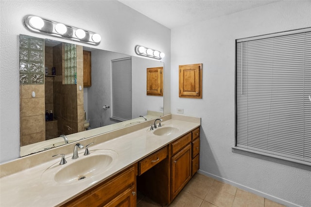 9518 County Road 913, Godley, TX 76044 - full bath featuring tile patterned floors, double vanity, a sink, and toilet