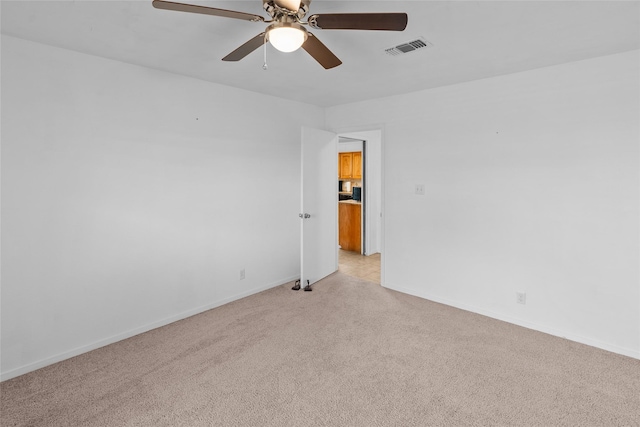 9518 County Road 913, Godley, TX 76044 - spare room featuring light carpet, visible vents, baseboards, and a ceiling fan