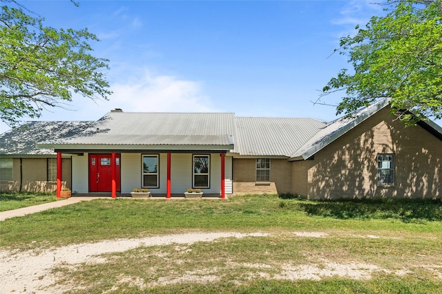 9518 County Road 913, Godley, TX 76044 - ranch-style home with a front yard, a porch, brick siding, and metal roof