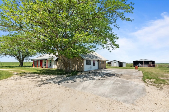 9518 County Road 913, Godley, TX 76044 - view of front of house with an outbuilding, concrete driveway, a pole building, and metal roof