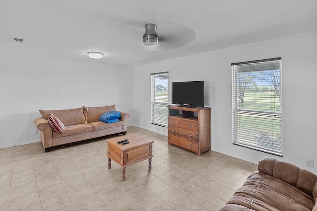 9518 County Road 913, Godley, TX 76044 - living room featuring crown molding, light tile patterned floors, a ceiling fan, visible vents, and baseboards