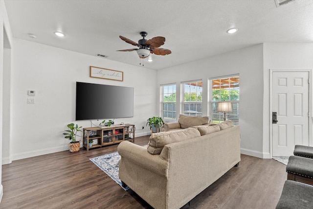 living area with baseboards, a ceiling fan, and wood finished floors