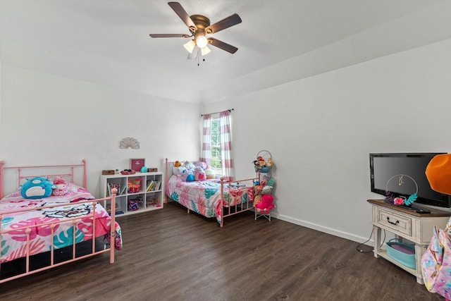 bedroom with ceiling fan, baseboards, and wood finished floors