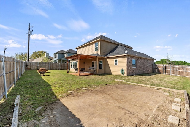 back of house featuring a patio area, a fenced backyard, and a yard