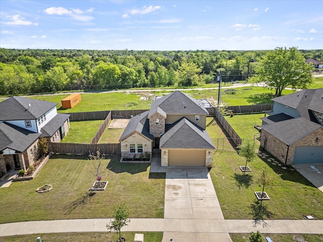 birds eye view of property with a forest view