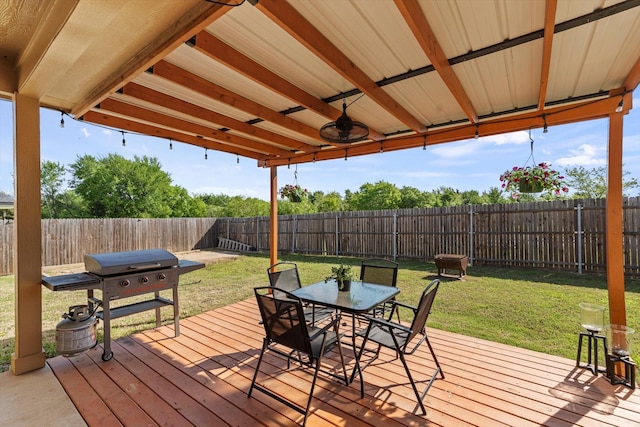 wooden deck with a yard, a fenced backyard, and outdoor dining area
