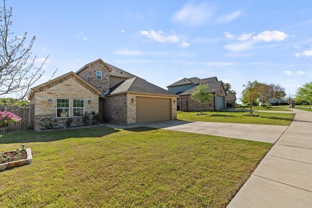 140 Egret Cir E, Tawakoni, TX 75472 - view of front of house featuring concrete driveway, an attached garage, brick siding, and stone siding