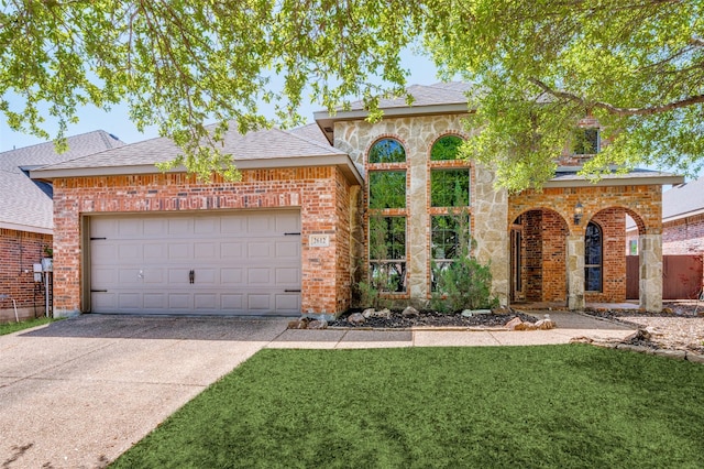 view of front facade with concrete driveway, brick siding, a garage, a front lawn, and roof with shingles