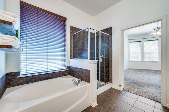 bathroom with a stall shower, a bath, tile patterned floors, and a ceiling fan