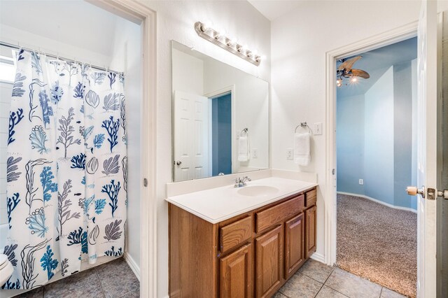 full bathroom with tile patterned floors, vanity, baseboards, and curtained shower