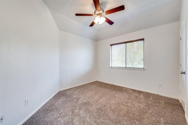 empty room with carpet floors, a ceiling fan, and baseboards