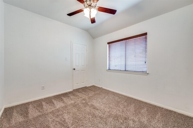 unfurnished room featuring carpet flooring, baseboards, lofted ceiling, and ceiling fan