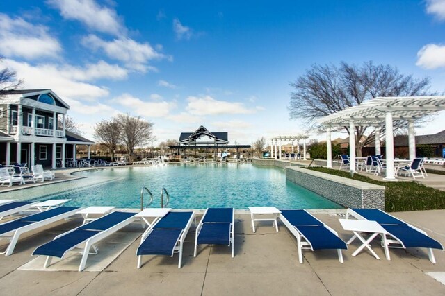 community pool with a pergola and a patio