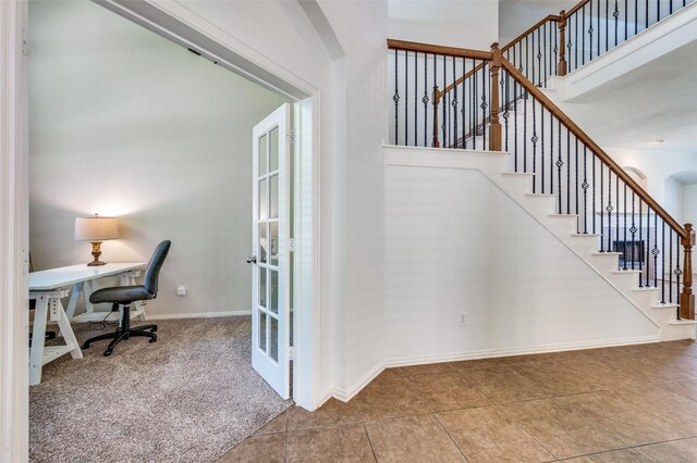 stairs featuring tile patterned flooring, carpet flooring, baseboards, and french doors