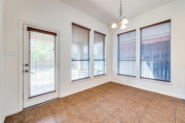 2612 Katie Trl, Melissa, TX 75454 - unfurnished dining area featuring a chandelier, light tile patterned floors, and baseboards