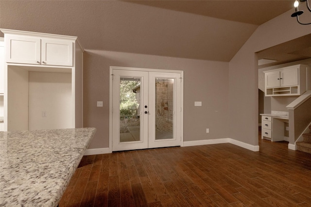 576 County Road 3555, Paradise, TX 76073 - interior space with baseboards, vaulted ceiling, french doors, white cabinetry, and dark wood-type flooring