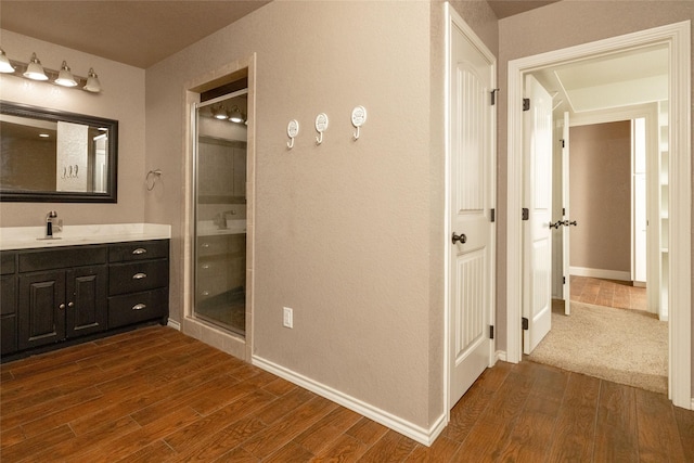 576 County Road 3555, Paradise, TX 76073 - full bath with vanity, baseboards, a stall shower, and wood finished floors