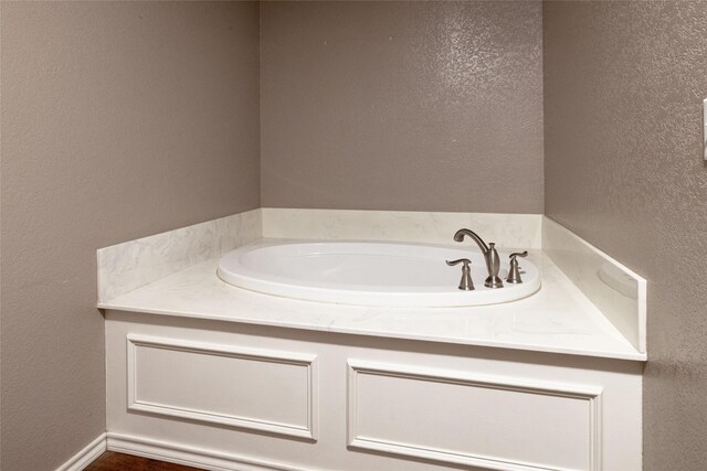 576 County Road 3555, Paradise, TX 76073 - bathroom with a textured wall and a garden tub