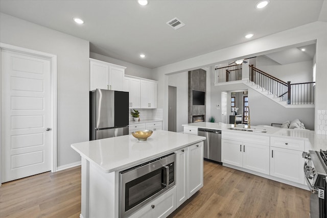 3506 Riley St, Fate, TX 75087 - kitchen with a sink, stainless steel appliances, light countertops, visible vents, and a kitchen island