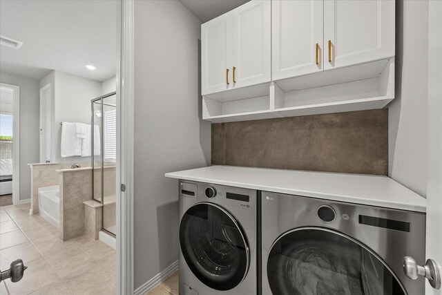 3506 Riley St, Fate, TX 75087 - washroom featuring separate washer and dryer, baseboards, light tile patterned floors, visible vents, and cabinet space