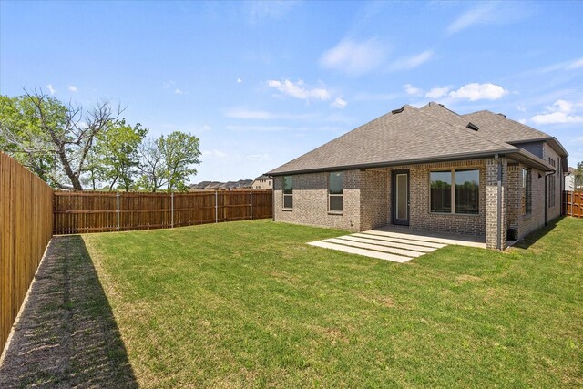 3506 Riley St, Fate, TX 75087 - back of property with a shingled roof, a patio area, a fenced backyard, and brick siding