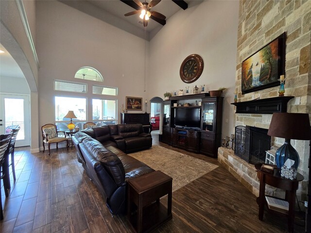 9812 El Colina Dr, Fort Worth, TX 76179 - living room with high vaulted ceiling, arched walkways, a stone fireplace, and a ceiling fan