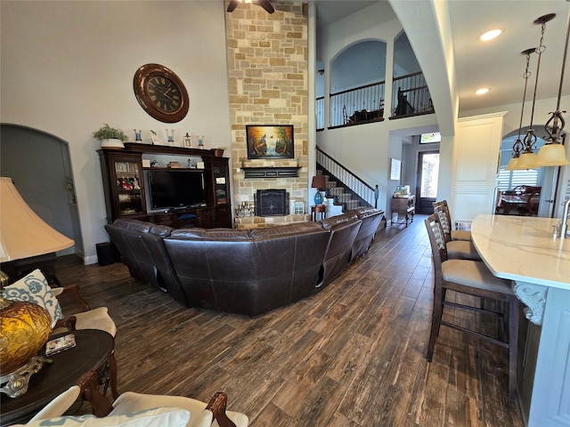 9812 El Colina Dr, Fort Worth, TX 76179 - living area featuring a fireplace, dark wood-style floors, and a towering ceiling
