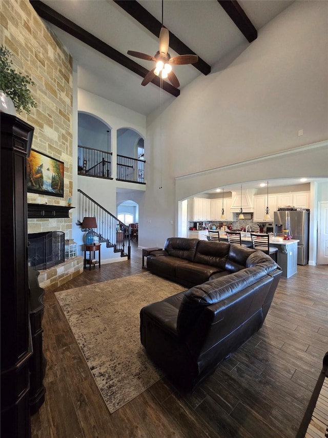 9812 El Colina Dr, Fort Worth, TX 76179 - living area featuring ceiling fan, a fireplace, beam ceiling, and dark wood-style flooring