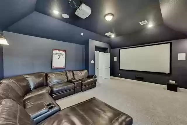 9812 El Colina Dr, Fort Worth, TX 76179 - carpeted home theater room with lofted ceiling
