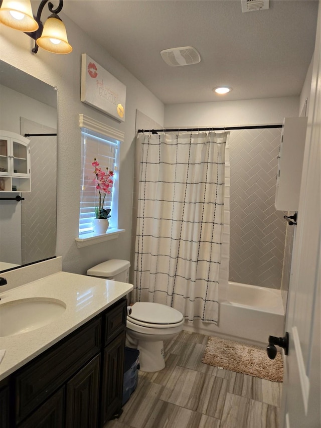 9812 El Colina Dr, Fort Worth, TX 76179 - bathroom featuring vanity, visible vents, toilet, shower / bath combo, and wood finished floors