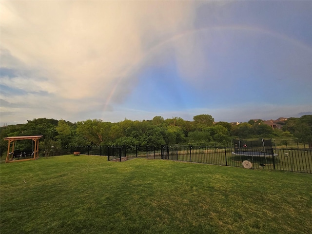 9812 El Colina Dr, Fort Worth, TX 76179 - view of yard with a trampoline and fence