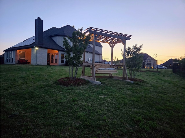9812 El Colina Dr, Fort Worth, TX 76179 - yard at dusk with fence and a pergola