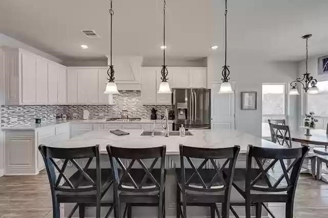 9812 El Colina Dr, Fort Worth, TX 76179 - kitchen with light countertops, a sink, backsplash, and appliances with stainless steel finishes