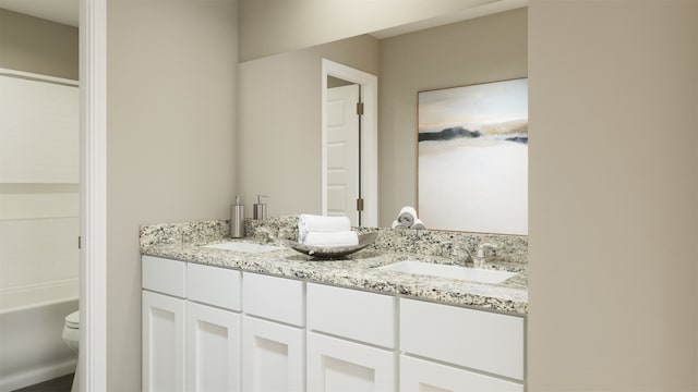 full bathroom featuring toilet, a bath, double vanity, and a sink
