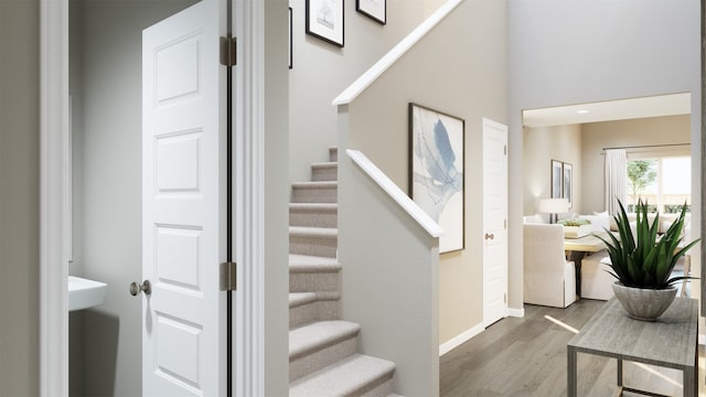 stairway with baseboards and wood finished floors