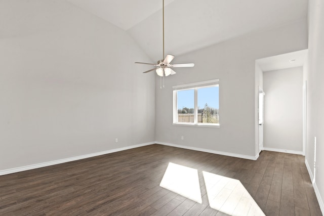 empty room with vaulted ceiling, ceiling fan, baseboards, and dark wood finished floors