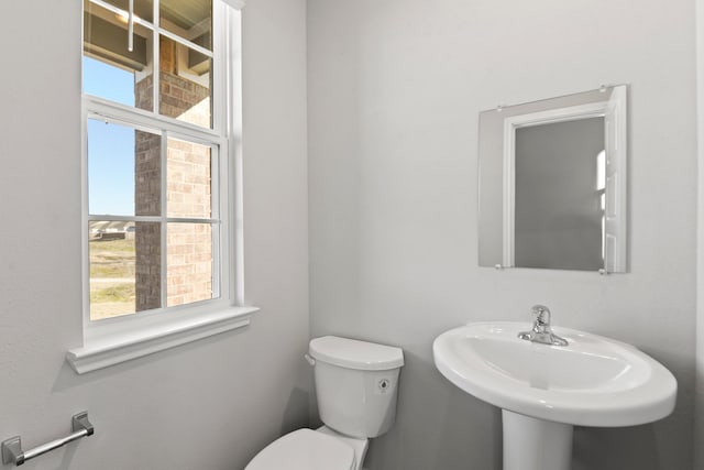 half bath with toilet and a sink