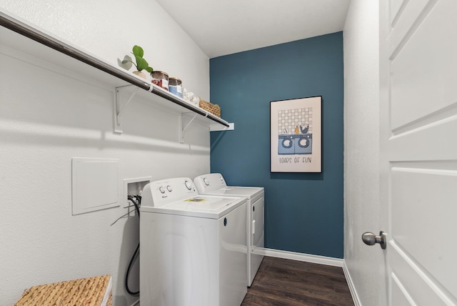 laundry room with laundry area, dark wood finished floors, baseboards, and washing machine and dryer