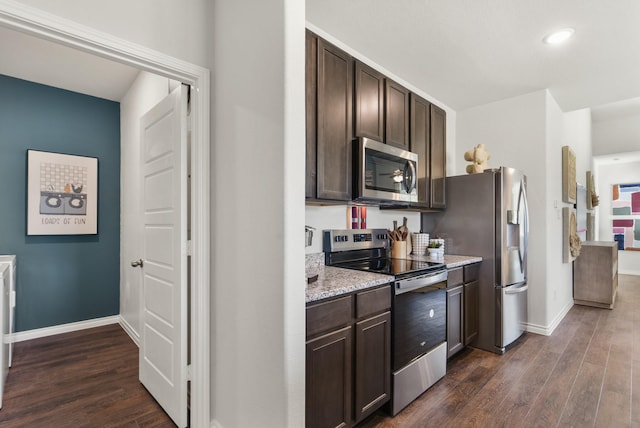 kitchen featuring recessed lighting, baseboards, dark brown cabinetry, appliances with stainless steel finishes, and dark wood-style floors