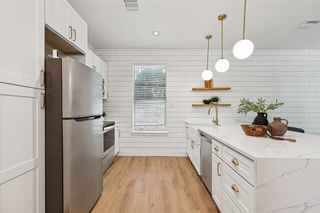 627 N Hampton Rd, Dallas, TX 75208 - kitchen with stainless steel appliances, a sink, open shelves, white cabinetry, and light wood-style flooring
