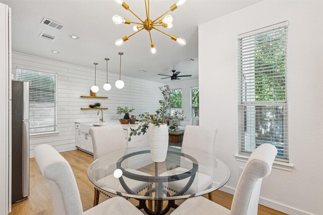 627 N Hampton Rd, Dallas, TX 75208 - dining space featuring baseboards, a chandelier, and light wood-style flooring