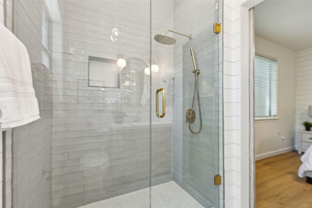627 N Hampton Rd, Dallas, TX 75208 - bathroom with a shower stall, wood finished floors, and baseboards
