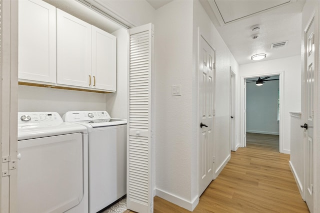 627 N Hampton Rd, Dallas, TX 75208 - washroom with cabinet space, light wood-type flooring, attic access, baseboards, and washer and clothes dryer